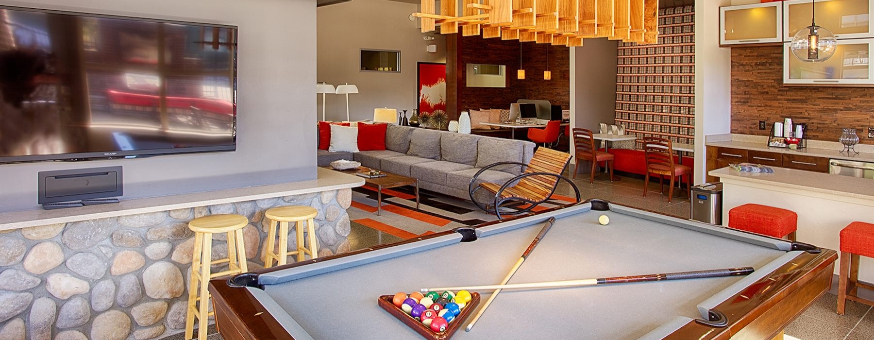 a clubroom with a tv and a pool table