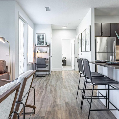 a living room with a table and chairs