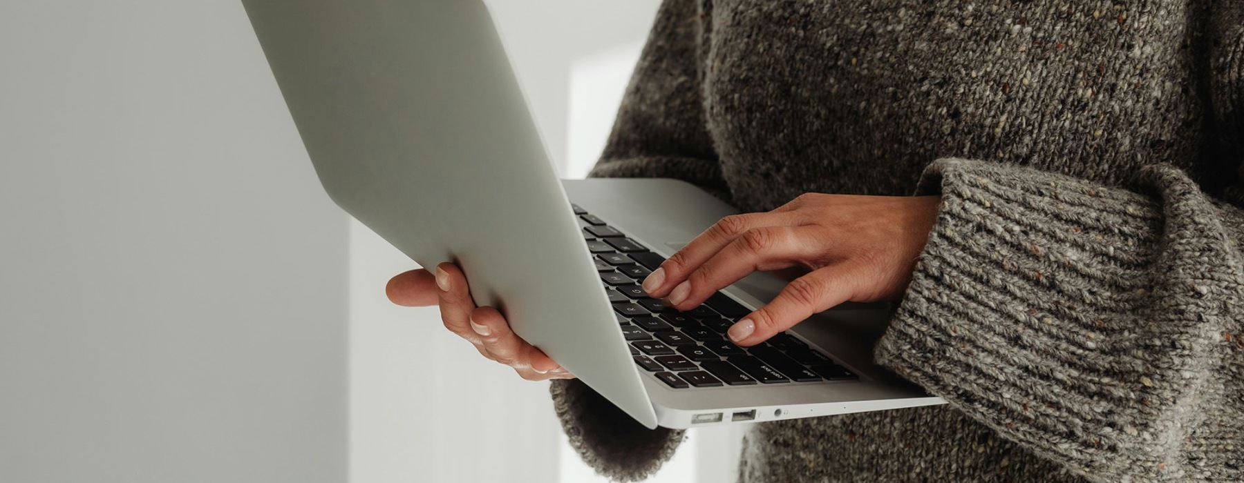 A person holding a laptop.