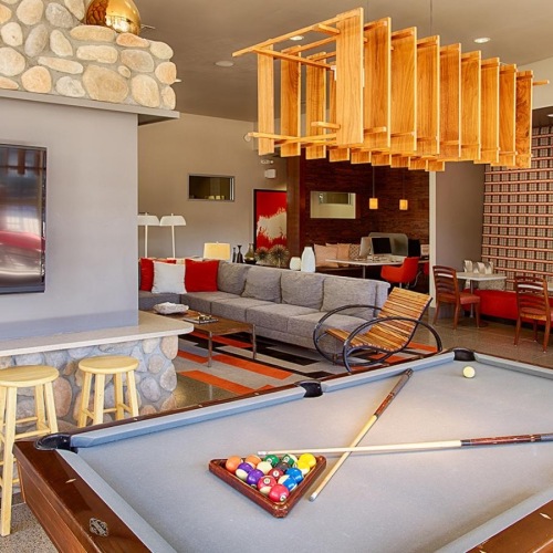 a clubroom with a tv and a pool table