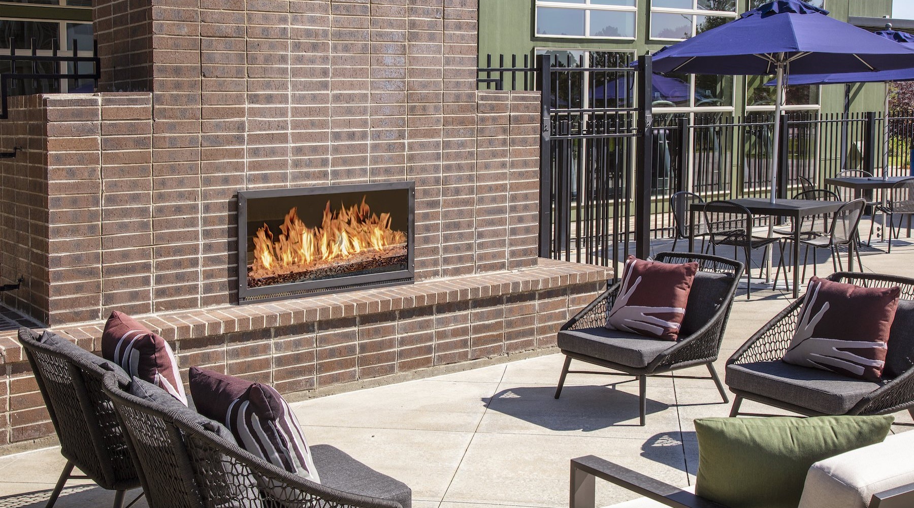 an outdoor fireplace with chairs